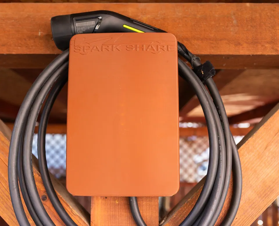 Orange SparkShare BOXEV on a wooden beam of a carport